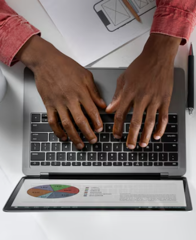 Hands building a product on a laptop